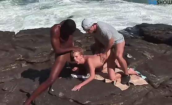 Interracial threesome at the beachside orgy